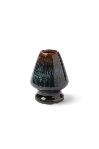 Ceramic matcha whisk stand with dark blue-green glossy glaze and rounded base