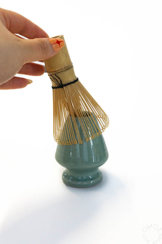 Matcha whisk with bamboo bristles on Seiji green ceramic stand