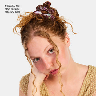 Purple marbled flower hair claw clip on a curly updo