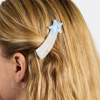 Light blue star hair clip clipped into blonde hair near the temple