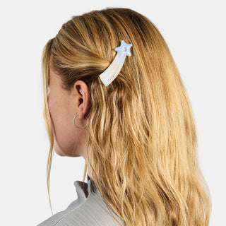 Star-shaped light blue hair clip on blonde hair, side view