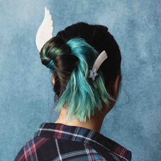 Shooting star hair clips on dark hair with teal highlights, back view