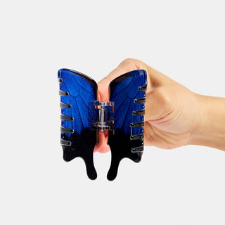 Swallowtail butterfly claw hair clip back view, blue wings with black grip teeth