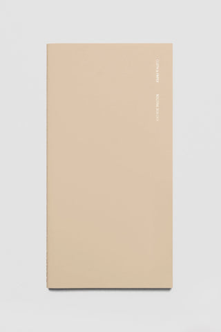 Beige A5 slim travel notebook, plain front cover with gold logo text