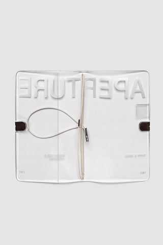 A5 slim travel notebook cover in clear vinyl, with metal clasp and pen loop
