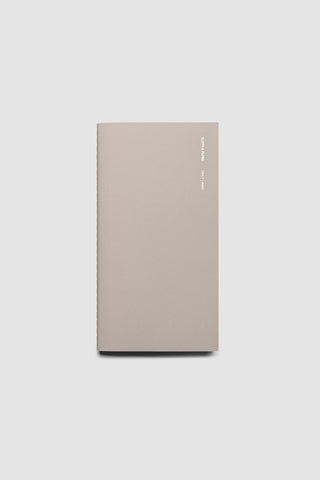 Beige travel notebook with smooth cover and vertical page edge