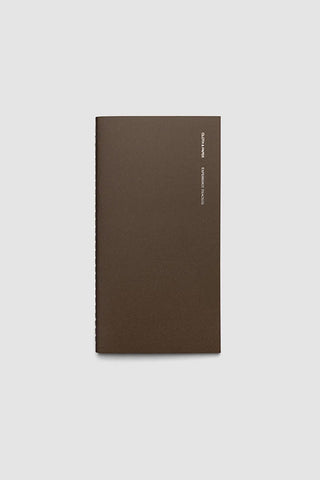 Brown travel notebook with vertical spine text