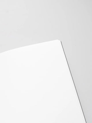 Close-up of notebook cover edge and page block, blank pages