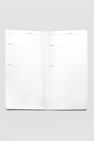 A5 daily lined notebook opened flat, two pages with section headings and numbered lines.