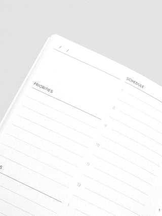 Close-up of daily planner lines with headings: Priorities and Schedule.