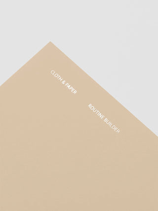 Beige A5 notebook cover with gold Cloth & Paper logo and Routine Builder text