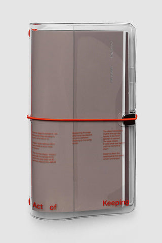 A5 clear vinyl notebook cover closed with red cord and transparent front