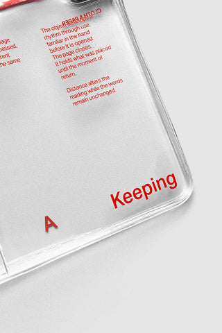 Clear vinyl notebook cover with 'Keeping' lettering and red elastic strap detail