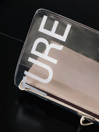 Clear vinyl notebook cover close-up with stitched corners and metal strap hardware
