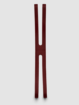 Burgundy notebook closure bands, two long straps with oval cutouts