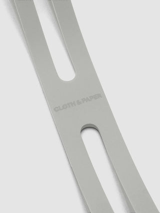 Light gray notebook closure band with oval slot and rounded hole cutout