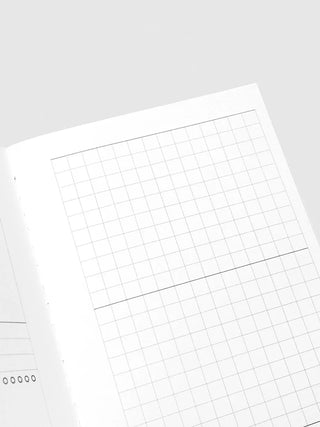 Open travel notebook close-up of large grid page with square lines