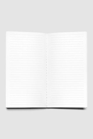 Open travel notebook with lined pages, lay-flat view