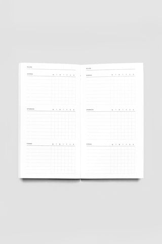 Open routine notebook with two-page layout of checklist tables and grids