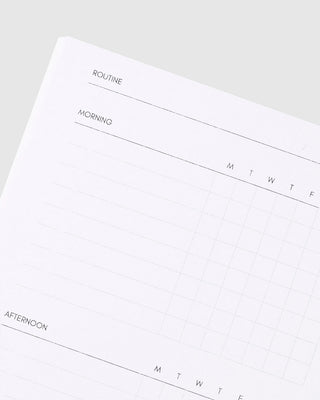 Open white routine planner page with morning and routine headings, weekly grid