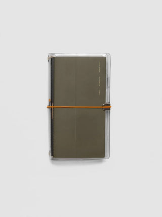 Olive vinyl travel cover with orange elastic bands and notebook spine.