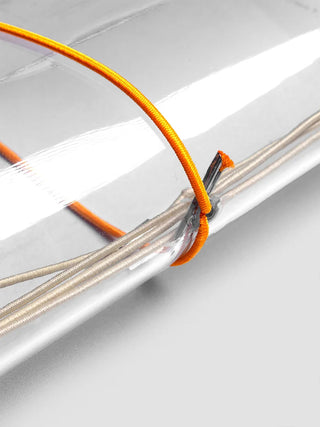 Silver-edged vinyl travel cover with orange elastic cord and knot.