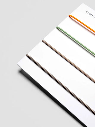 Vinyl notebook travel cover with three colored elastic bands along edge.