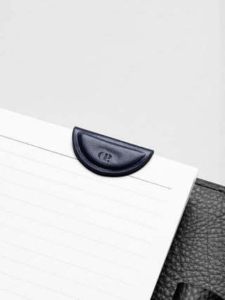Navy mini magnetic bookmark crescent clip with embossed logo on notebook page