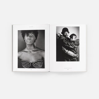 Open monograph book spread featuring two black-and-white portrait photos