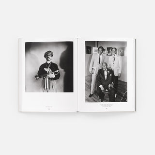 Open monograph book spread with two black-and-white photos of people posing