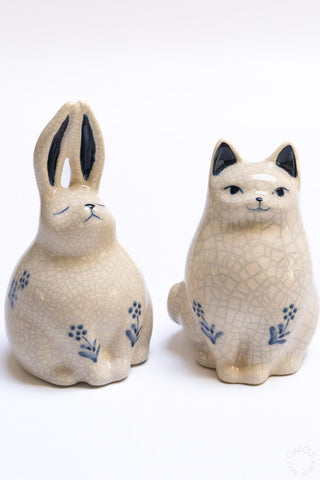 Two crackle porcelain rabbit incense burners with blue floral decals, seated on bases
