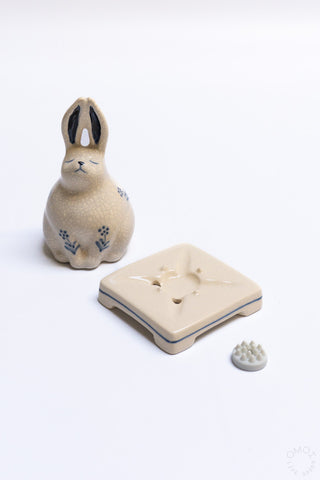 Rabbit incense burner base with crackle glaze, blue paw-flower motif, and small incense piece