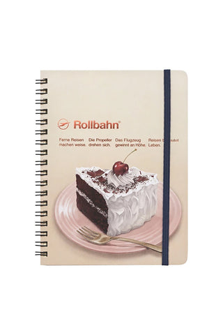 Large spiral notebook with cream cover, blue spine and Devil's Food cake front graphic