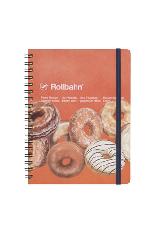 Large spiral notebook with donut cover art and blue elastic band, Rollbahn branding