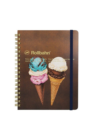 Spiral notebook with brown ice-cream cover, gold rings, and navy elastic band