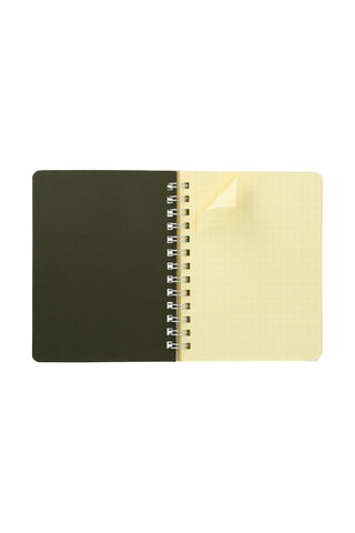 Pocket memo spiral notebook with dark cover and cream grid pages, metal rings