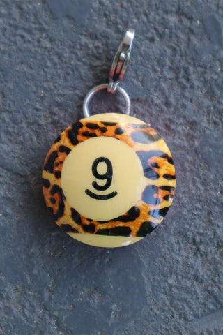 Round leopard-print pool charm with number 9 smiley face and metal bail