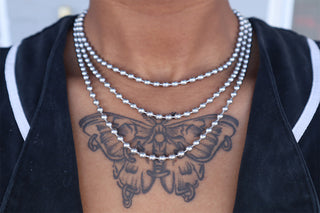 Silver ball chain necklaces on neck with small bead-like links