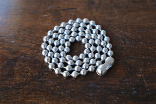 Coiled silver ball chain necklace with clasp at one end