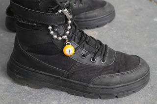 Mini pool charm with orange round bead labeled 1 on black boot lace