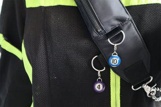 Mini pool charm with purple bead labeled 4 and blue bead labeled 10 on jacket