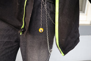 Person wearing a dark jacket with a chain and a #9 yellow ball keychain