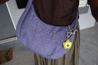 Purple shoulder bag with silver star-maille chain, dark star clips, and lime charm