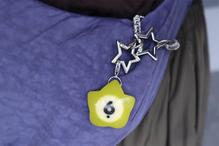 Star-maille chain with dark star clips and lime charm marked 6 on bag