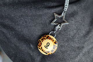 Star-maille chain with dark star clips and leopard round charm marked 9