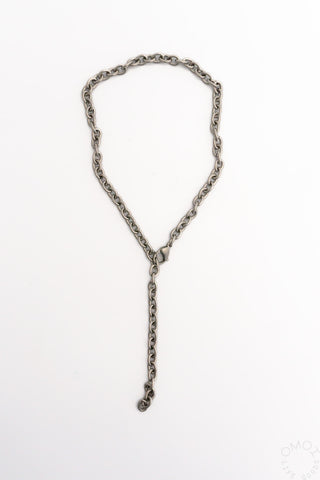 Silver-tone chain necklace with elongated hanging charm and small circular detail