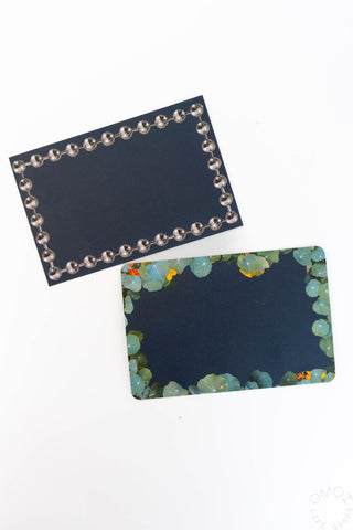 Two postcards: dark bordered bead frame and blue garden mosaic scene