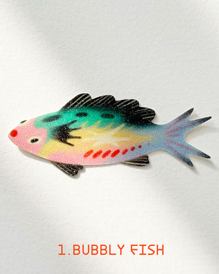 Glitter Bubbly fish sticker in mint, pink, and black with red accents