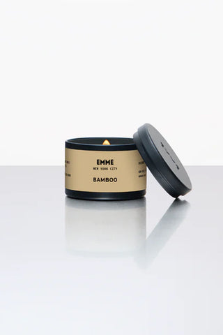 EMME bamboo tin candle with black lid, open wax top and small flame
