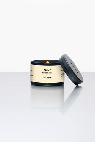 Lychee-scented candle in black-and-cream metal tin with matching black lid